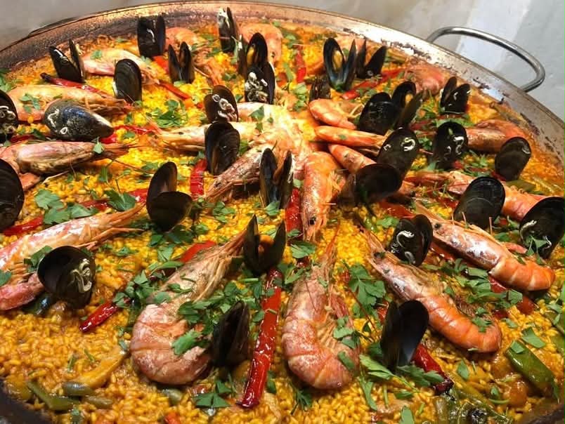 A seafood paella with prawns, mussels and saffron rice, cooked by Simon in Spain